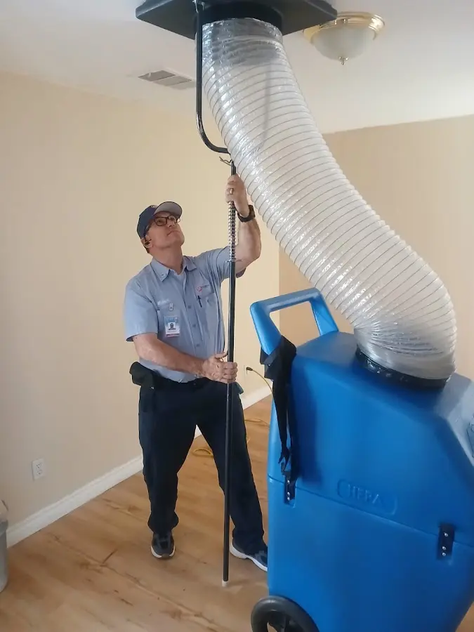 Furnace Tune-Up technician using HEPA equipment in Nephi
